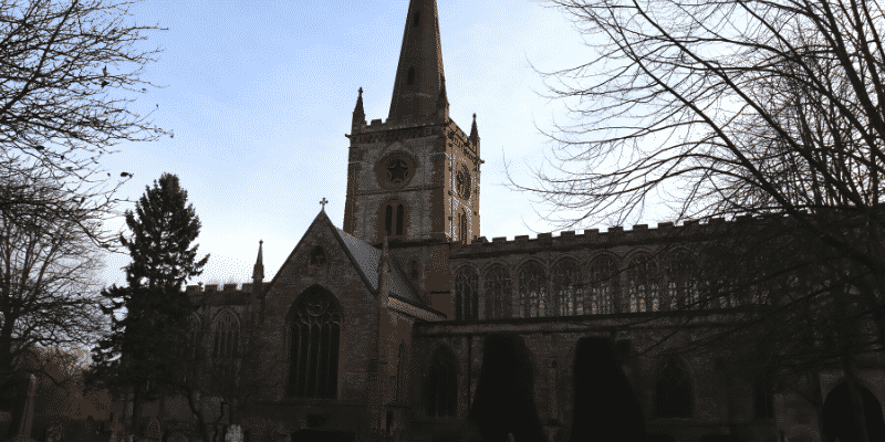 External shot of Shakespeare's Holy Trinity church, showing chancel and spire
